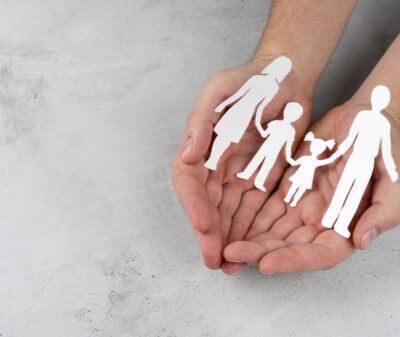 close-up-hands-holding-paper-family close-up-hands-holding-paper-family